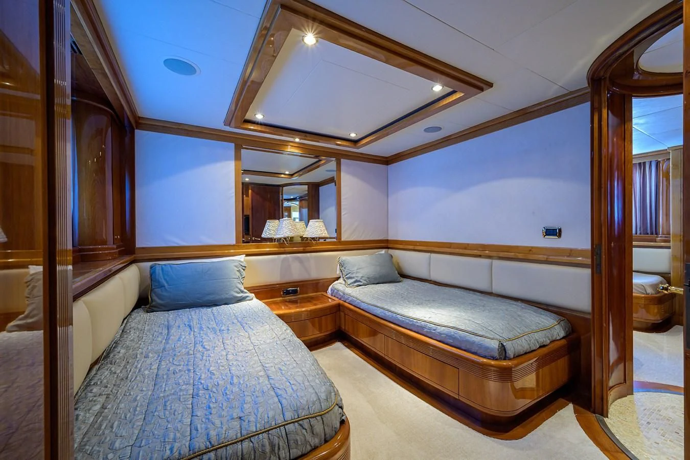 a room with a bed and a mirror aboard AVA Yacht for Sale
