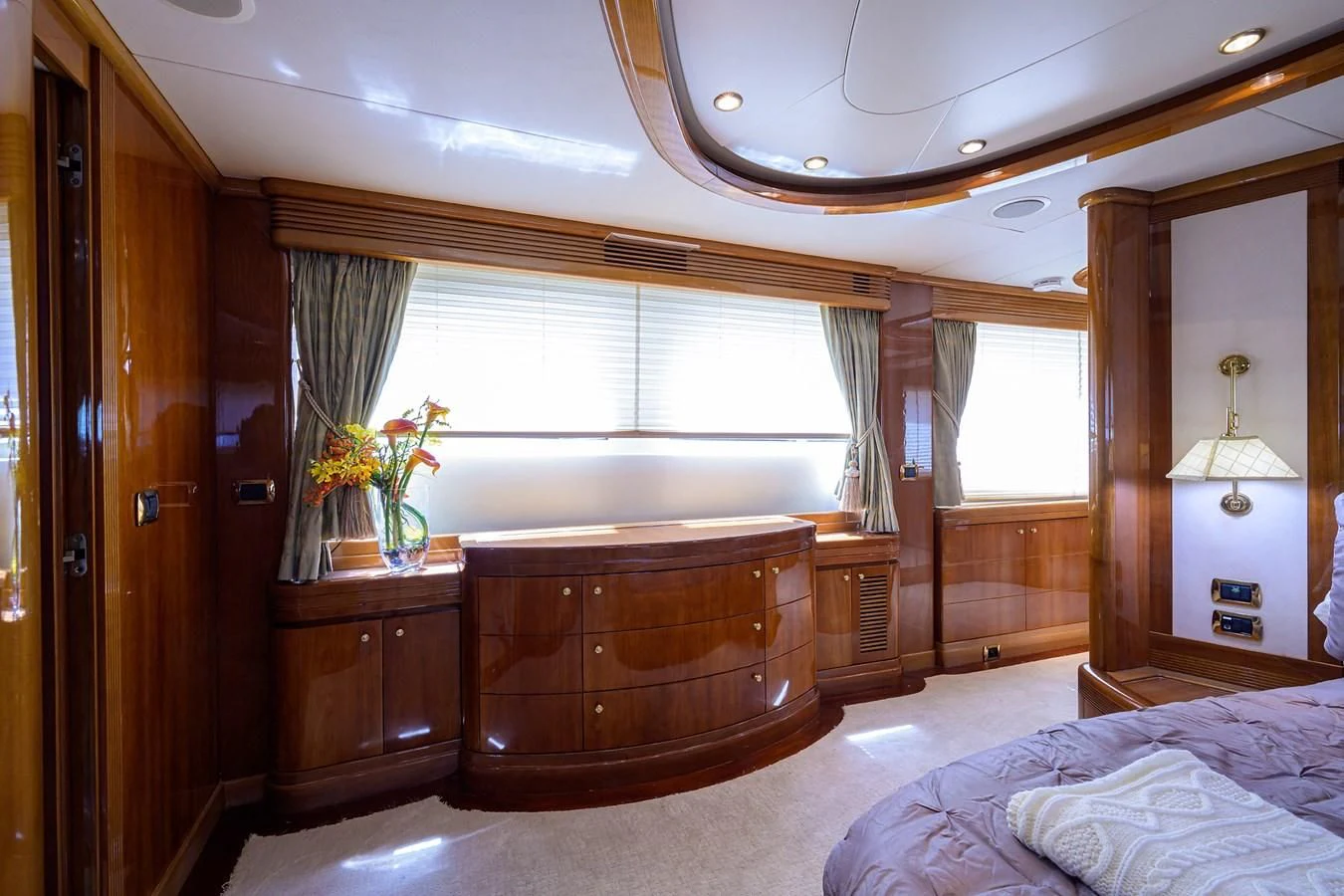 a bedroom with a bed and a dresser aboard AVA Yacht for Sale