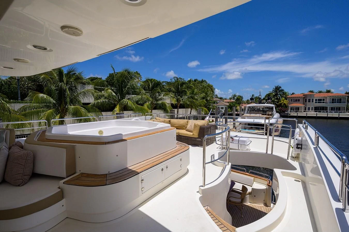 a pool with a lounge chair and a large building in the background aboard AVA Yacht for Sale