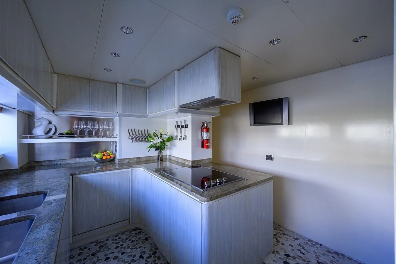 a kitchen with white cabinets aboard AVA Yacht for Sale