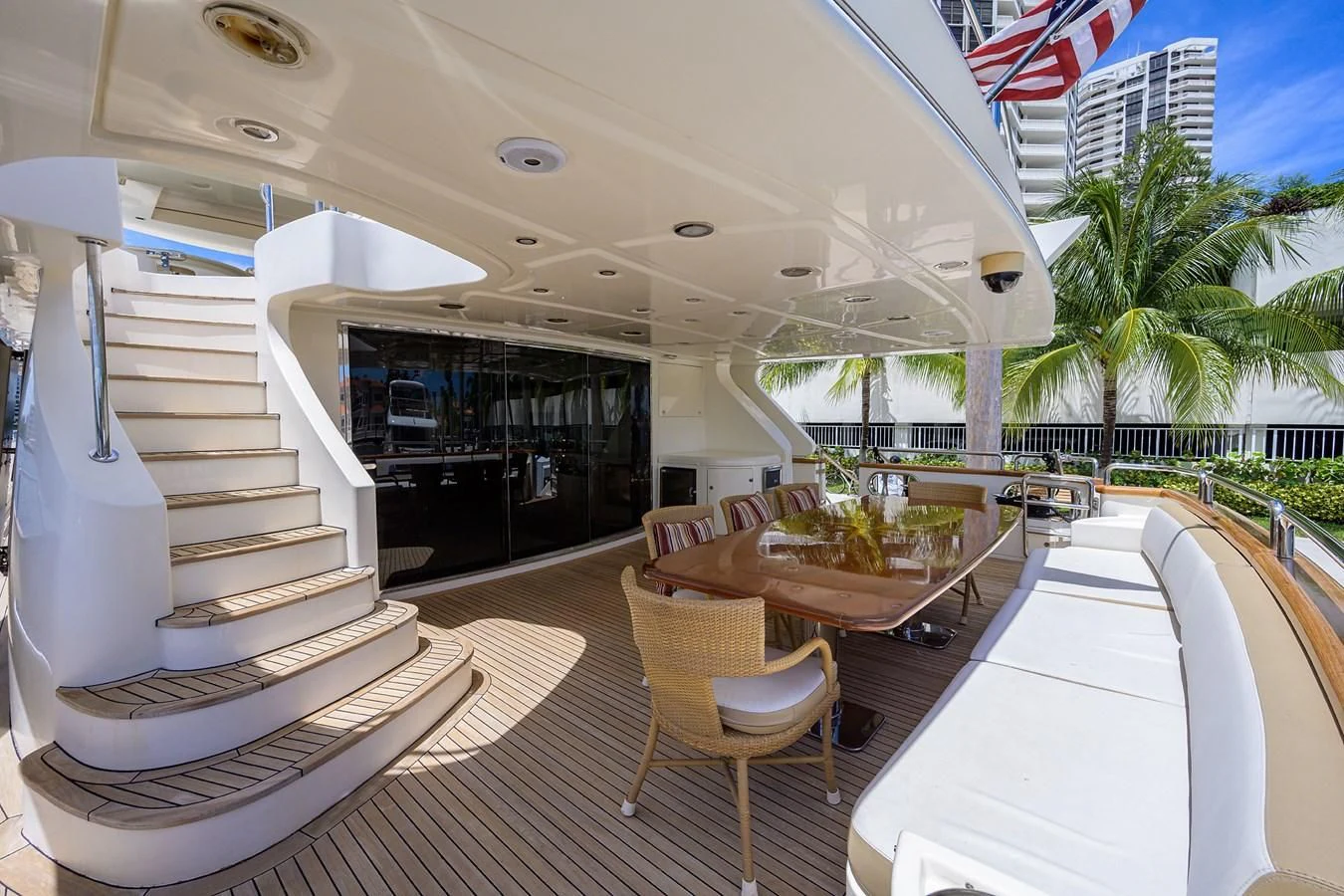 a balcony with a table and chairs aboard AVA Yacht for Sale