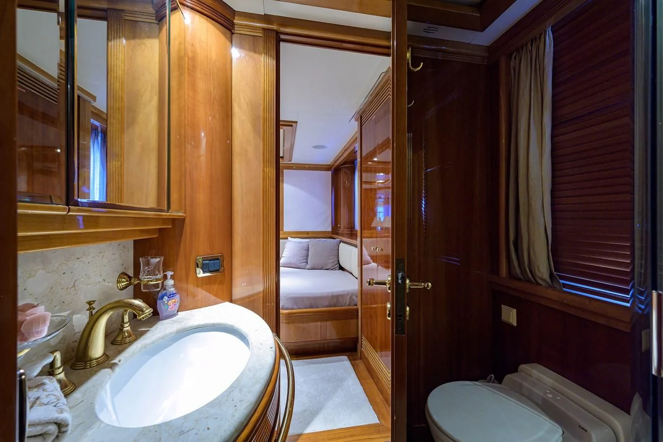 a bathroom with a sink and a bed aboard AVA Yacht for Sale