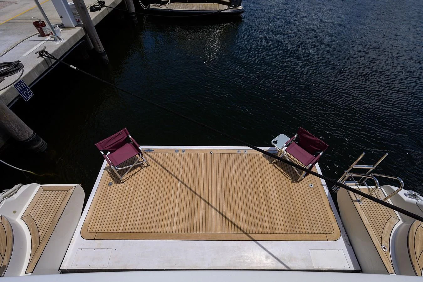 a deck with a chair on it by a body of water aboard AVA Yacht for Sale