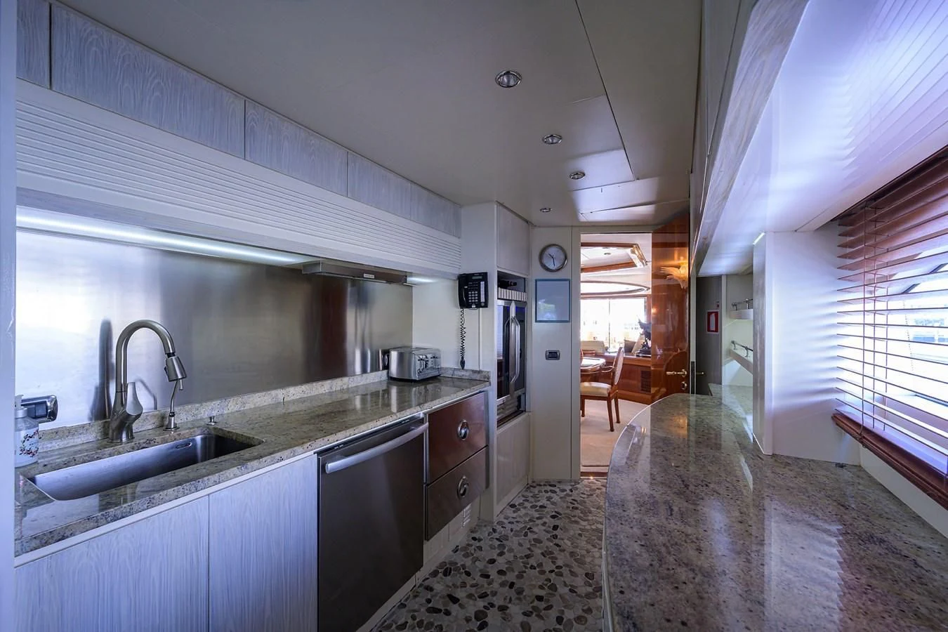 a kitchen with a marble counter top aboard AVA Yacht for Sale