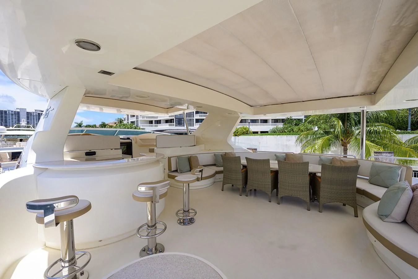 a large white lounge area with a table and chairs aboard AVA Yacht for Sale