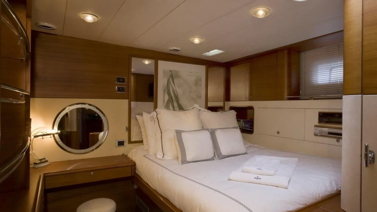 a room with a bed and a mirror aboard ZANZIBAR Yacht for Sale
