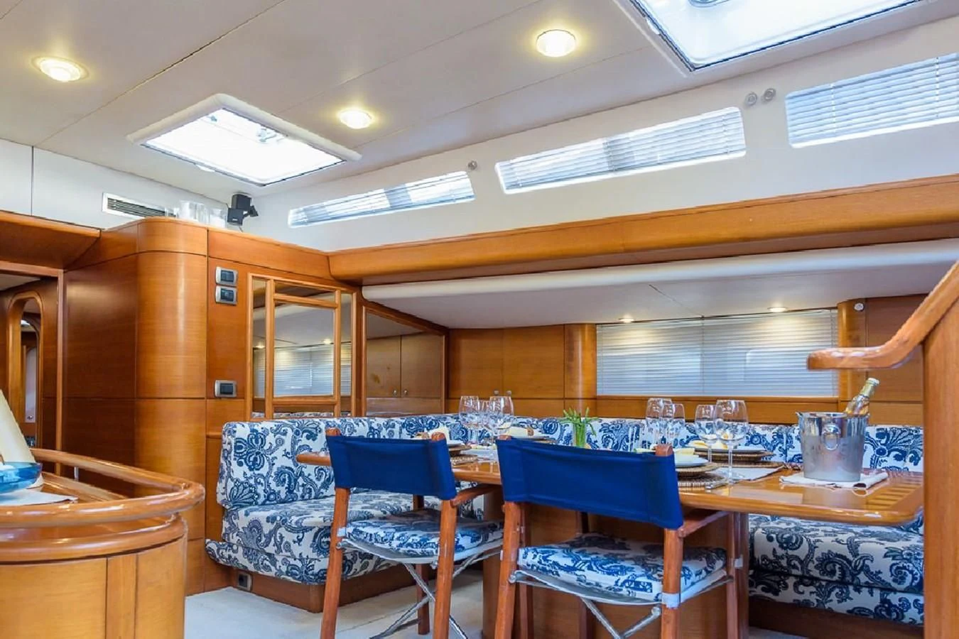 a room with a table chairs and a large window aboard ZANZIBAR Yacht for Sale