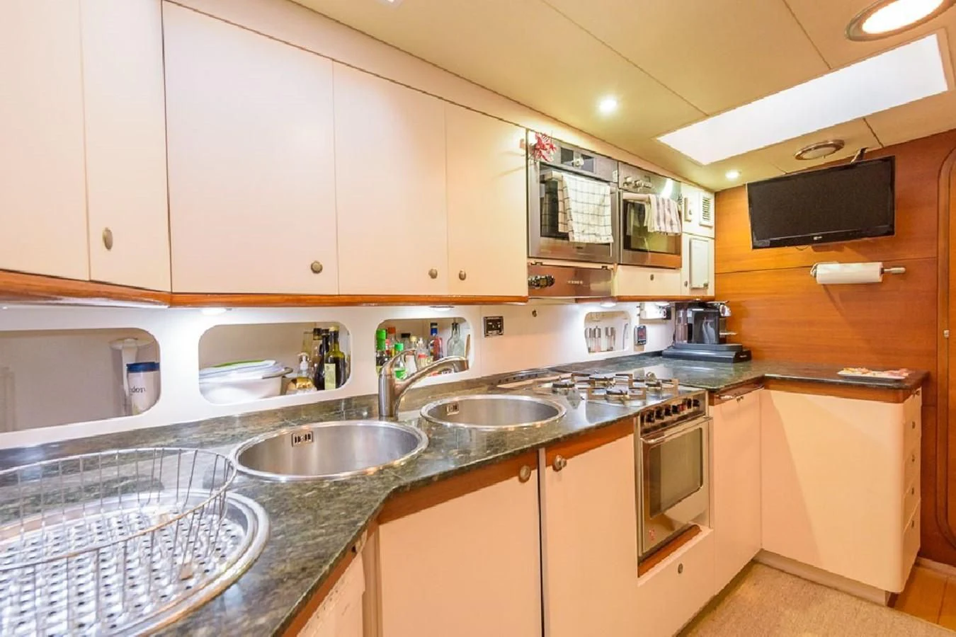 a kitchen with white cabinets aboard ZANZIBAR Yacht for Sale