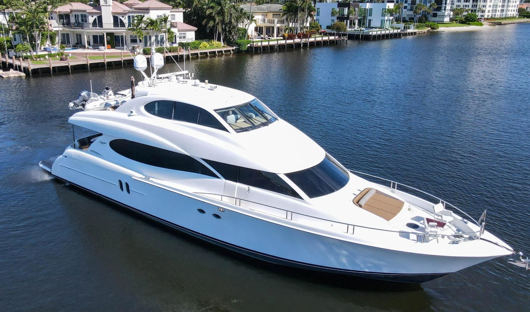 a white yacht in a harbor aboard XCELL Yacht for Sale