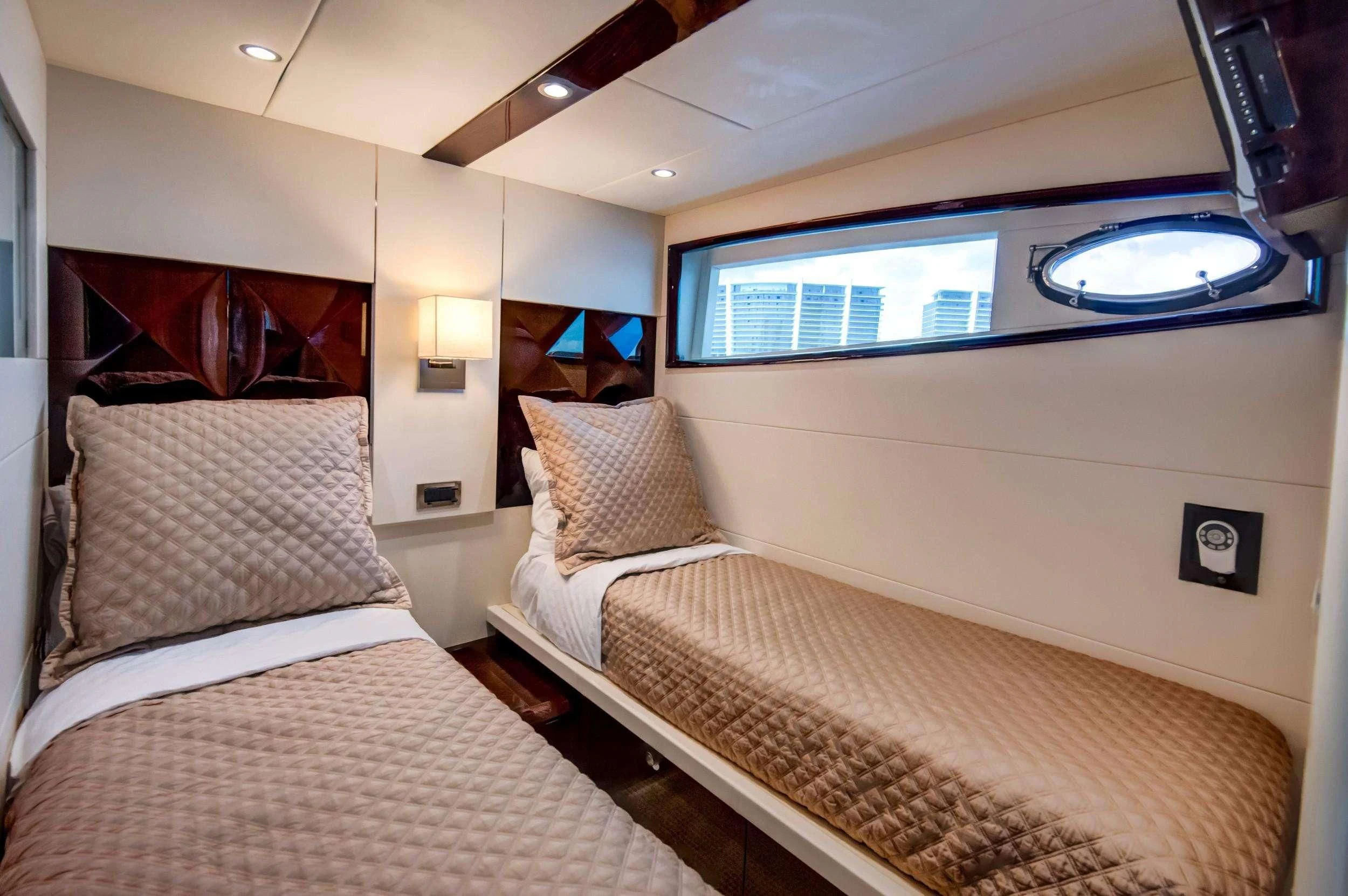 a couple of beds in a room aboard XCELL Yacht for Sale