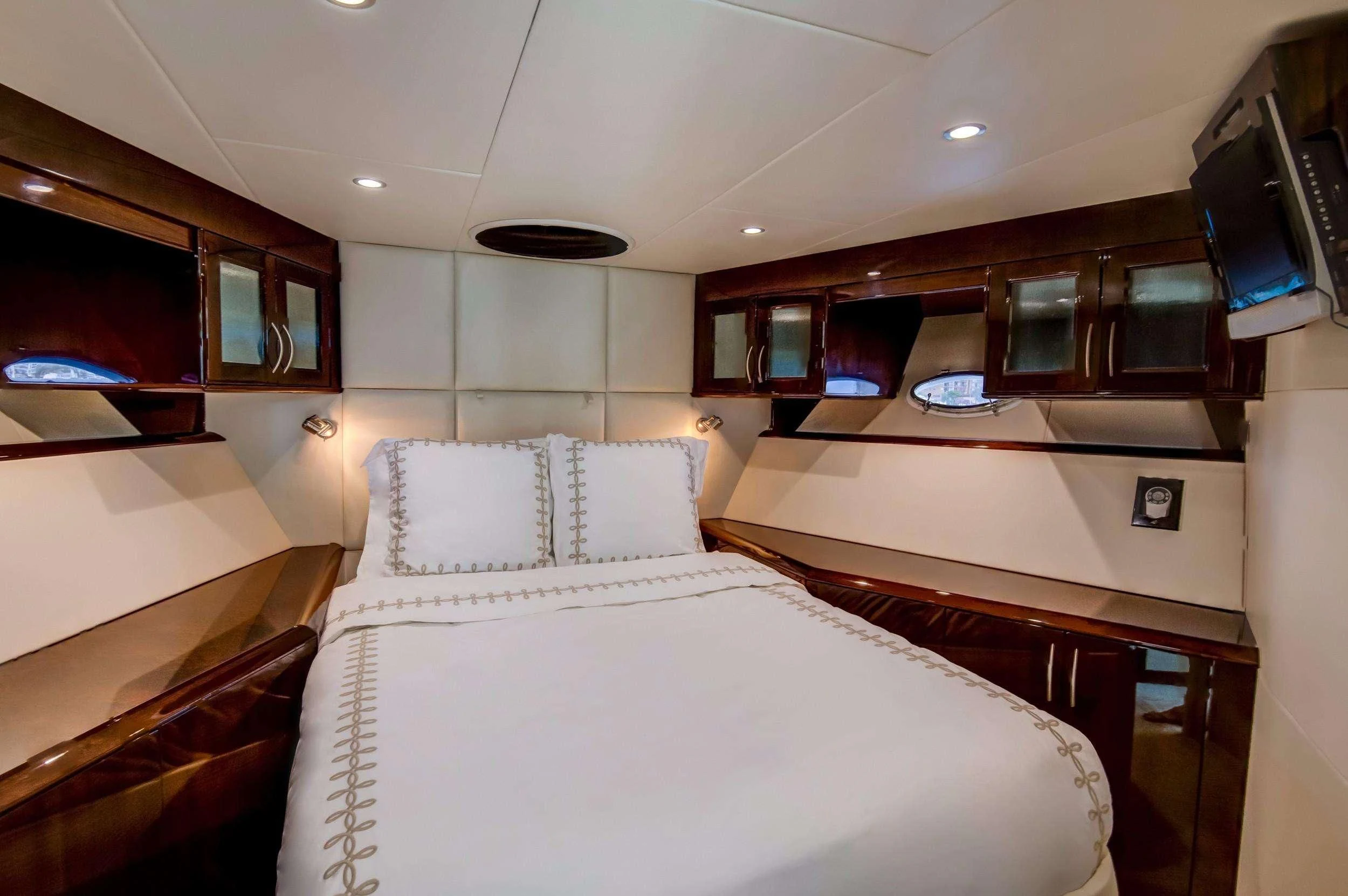 a room with a bed and a tv aboard XCELL Yacht for Sale