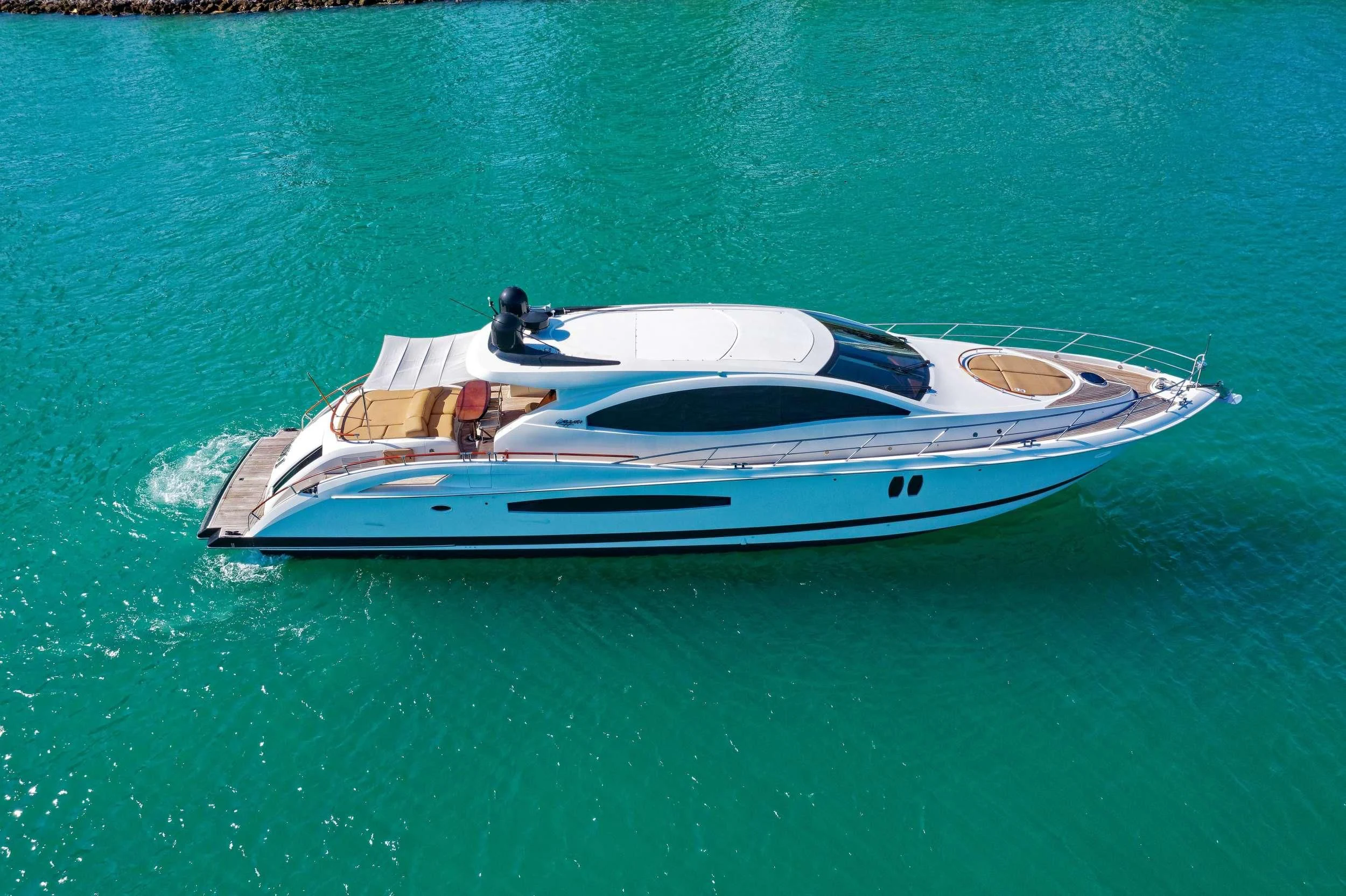 a white boat on the water aboard XCELL Yacht for Sale