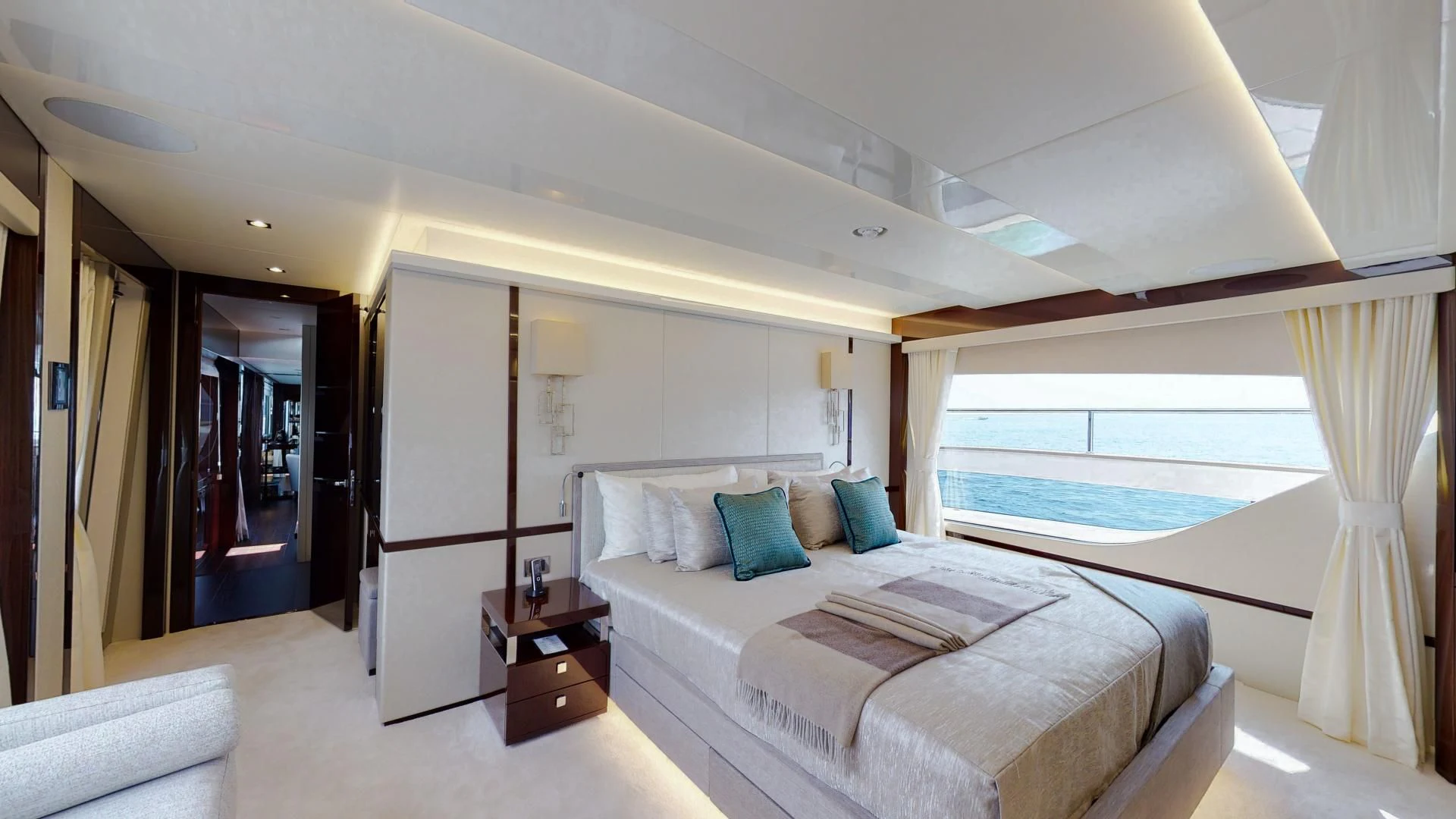 a bedroom with a bed and a window aboard PV 95 Yacht for Sale