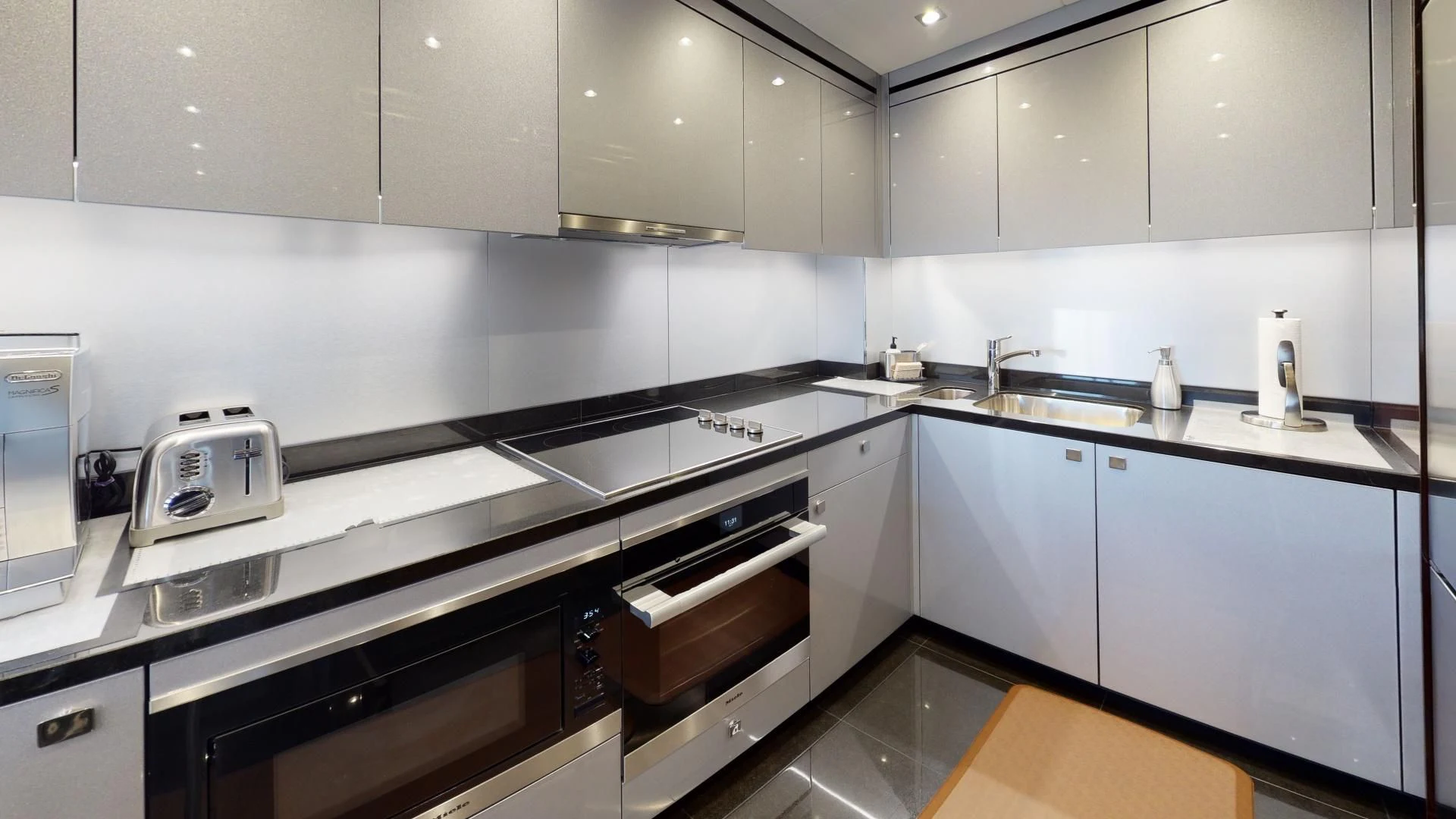 a kitchen with white cabinets aboard PV 95 Yacht for Sale