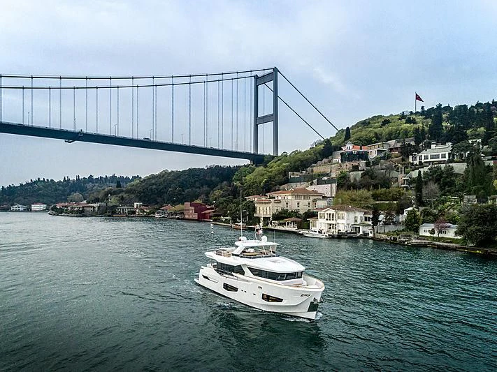 a boat sailing under a bridge aboard MARINAR Yacht for Sale