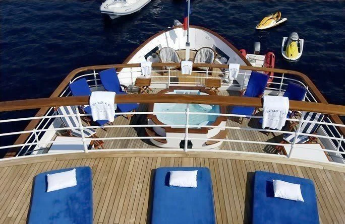 a boat with a deck and chairs aboard LADY K II Yacht for Sale