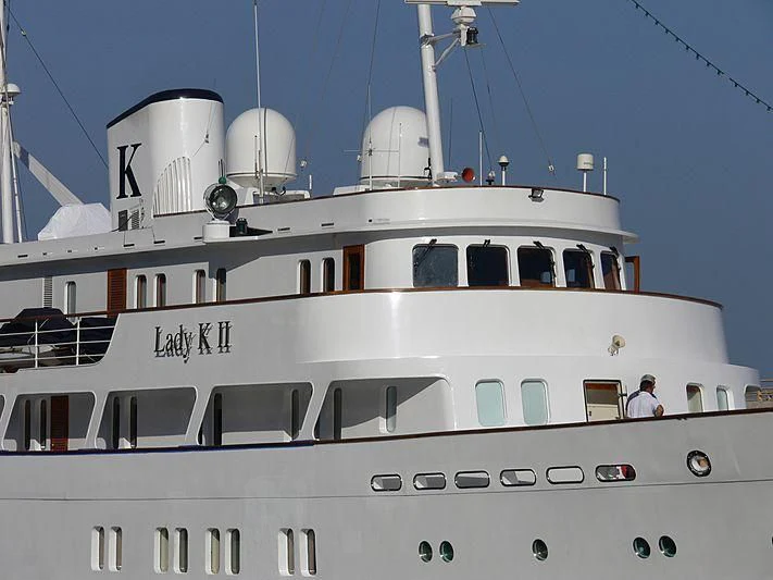 a white boat with a white dome with Spanish City in the background aboard LADY K II Yacht for Sale