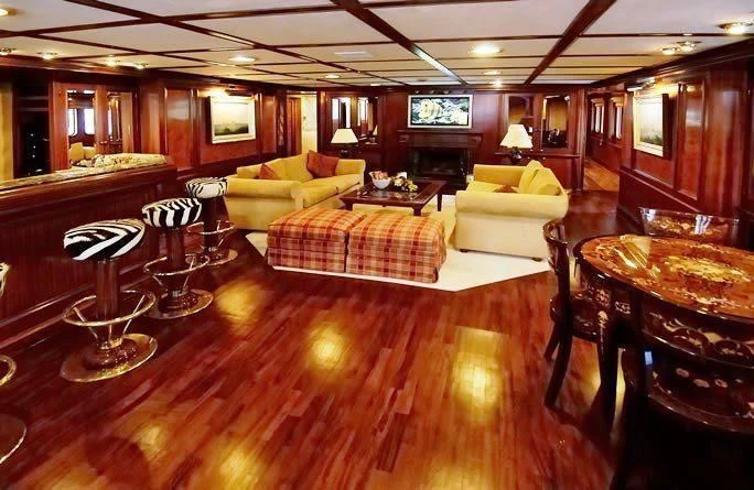 a living room with a wood floor aboard LADY K II Yacht for Sale