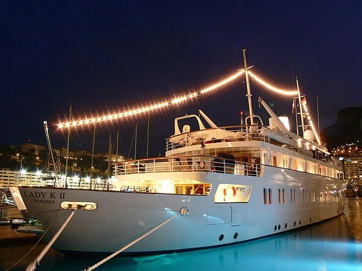 a boat with lights on at night aboard LADY K II Yacht for Sale