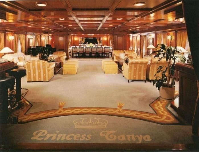 a large room with a large gold carpet and a gold star aboard LADY K II Yacht for Sale