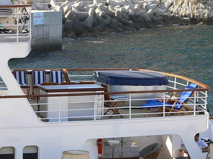 a boat with chairs on the deck aboard LADY K II Yacht for Sale
