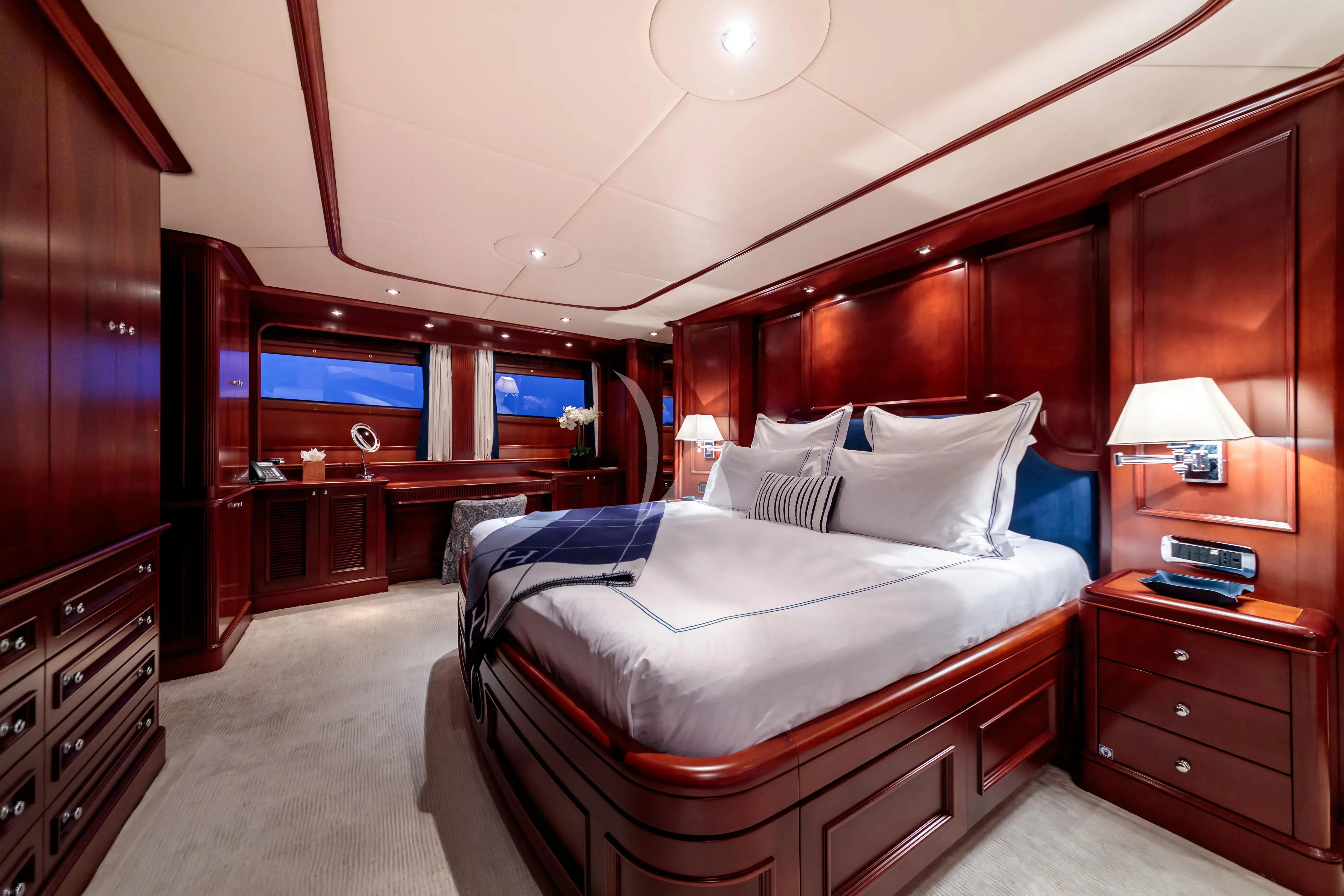 a room with a bed and a desk aboard BANG! Yacht for Charter