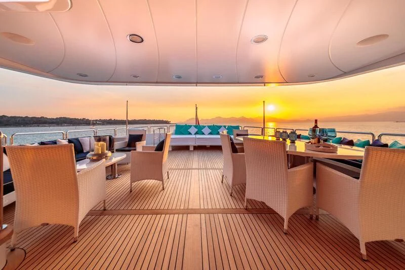 a room with tables and chairs aboard BANG! Yacht for Charter