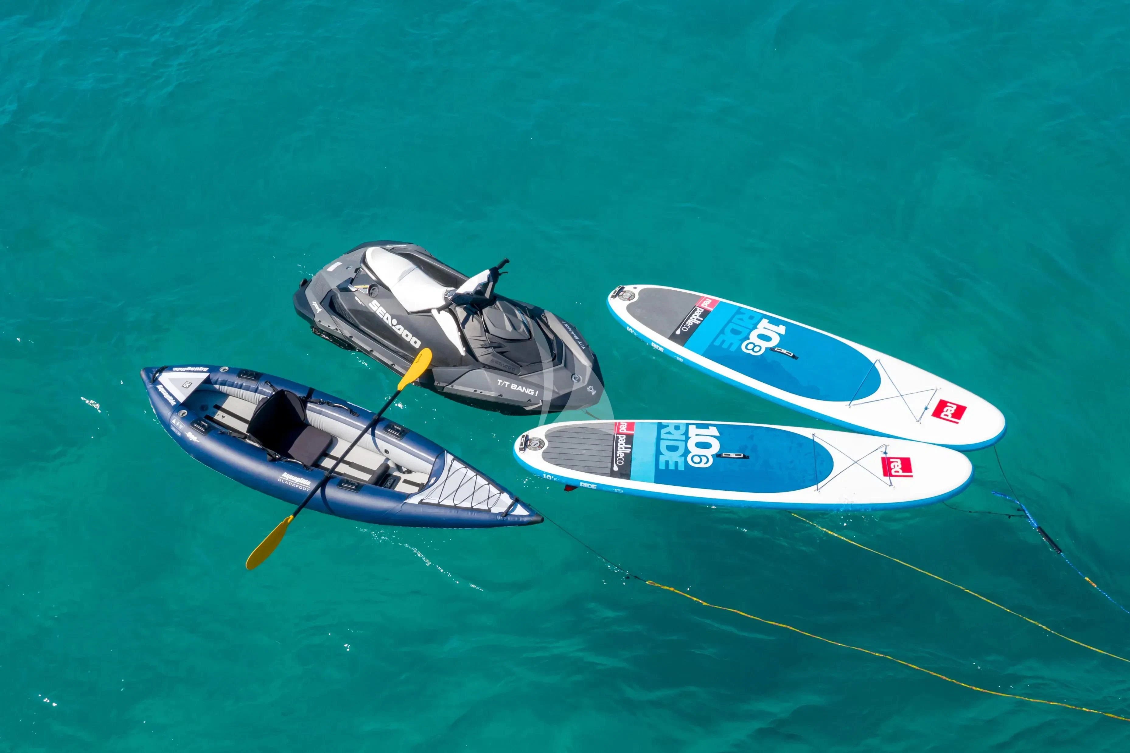 a couple of boats sit in the water aboard BANG! Yacht for Charter