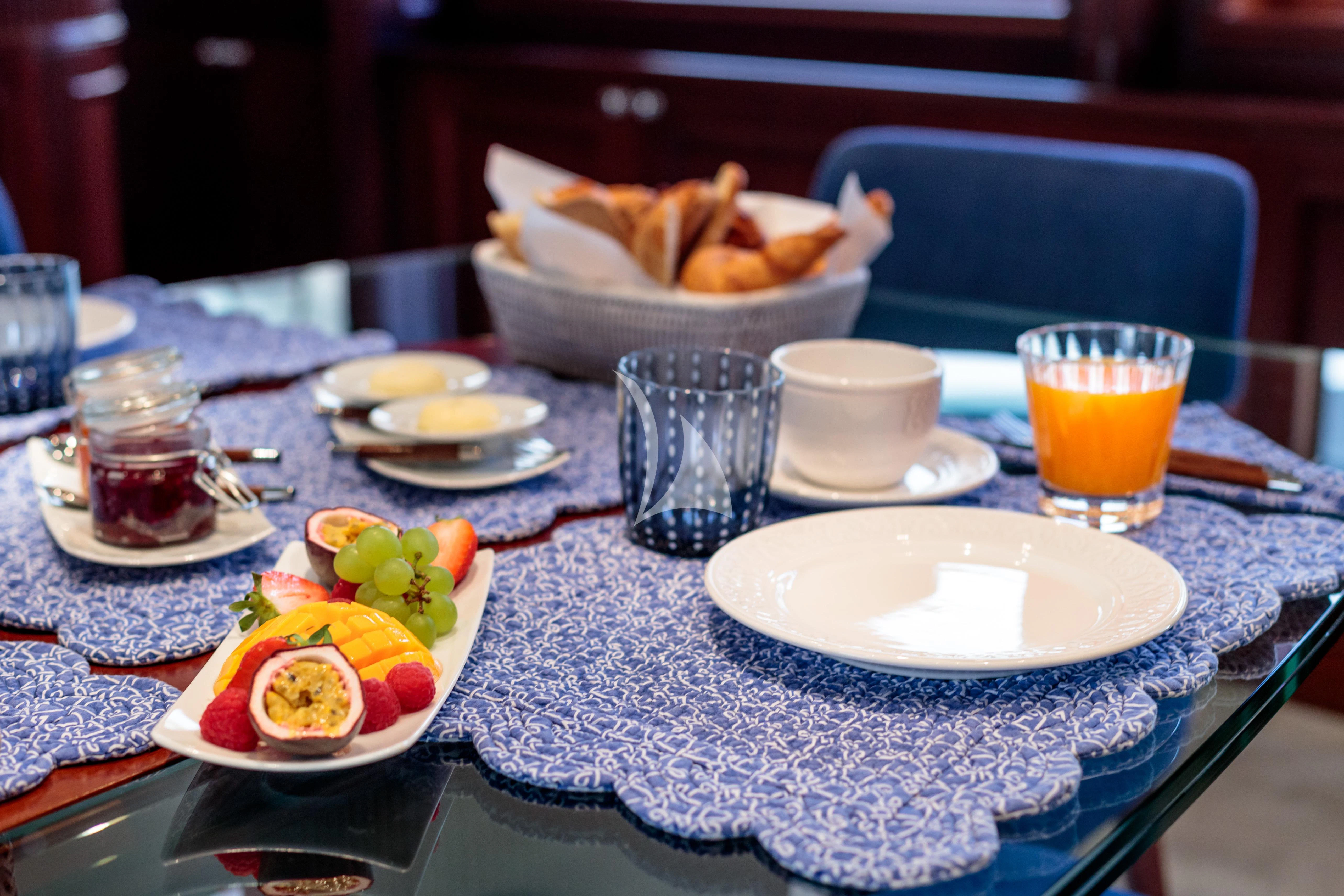 a table with plates and food on it aboard BANG! Yacht for Charter