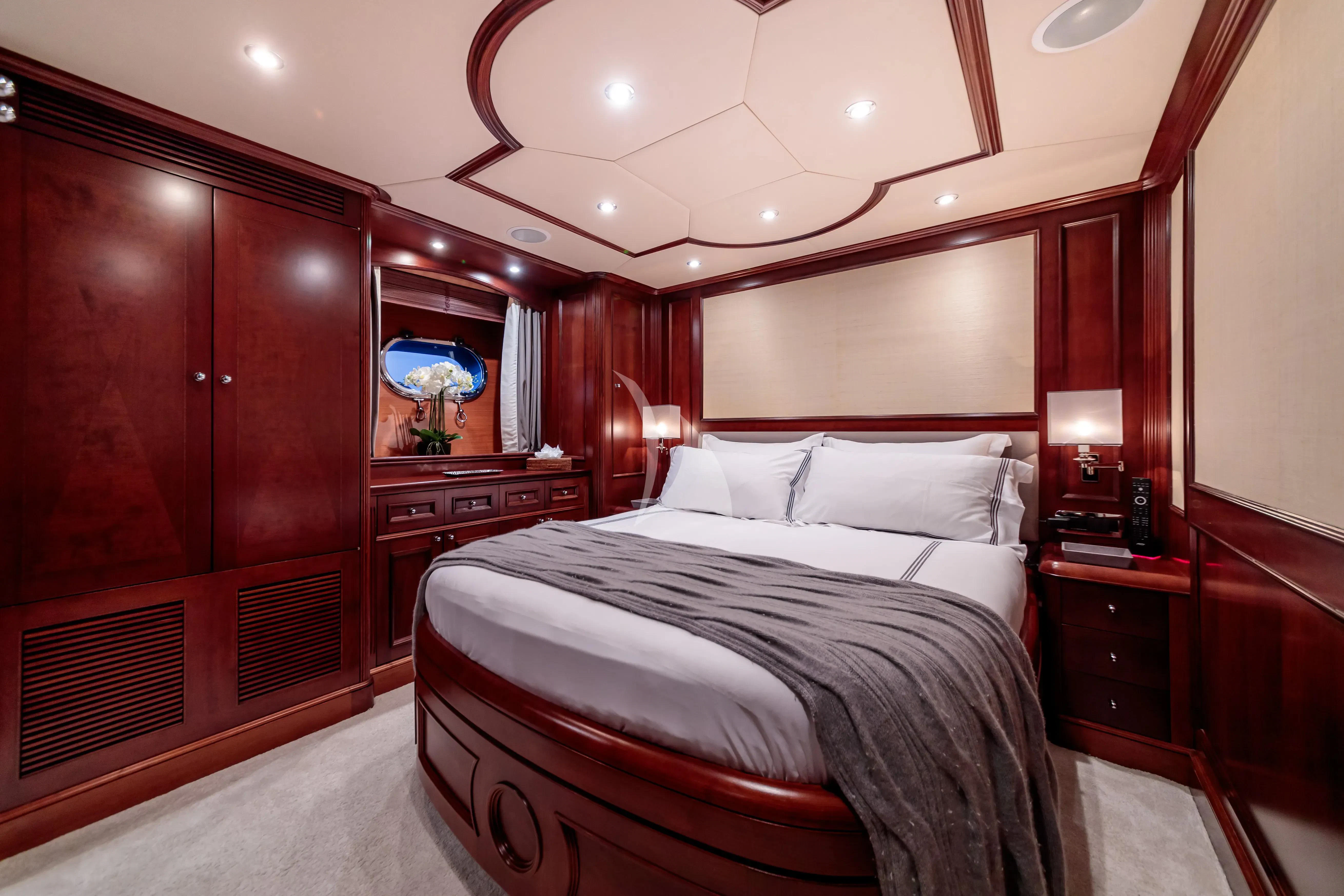 a bedroom with a bed and a desk aboard BANG! Yacht for Charter