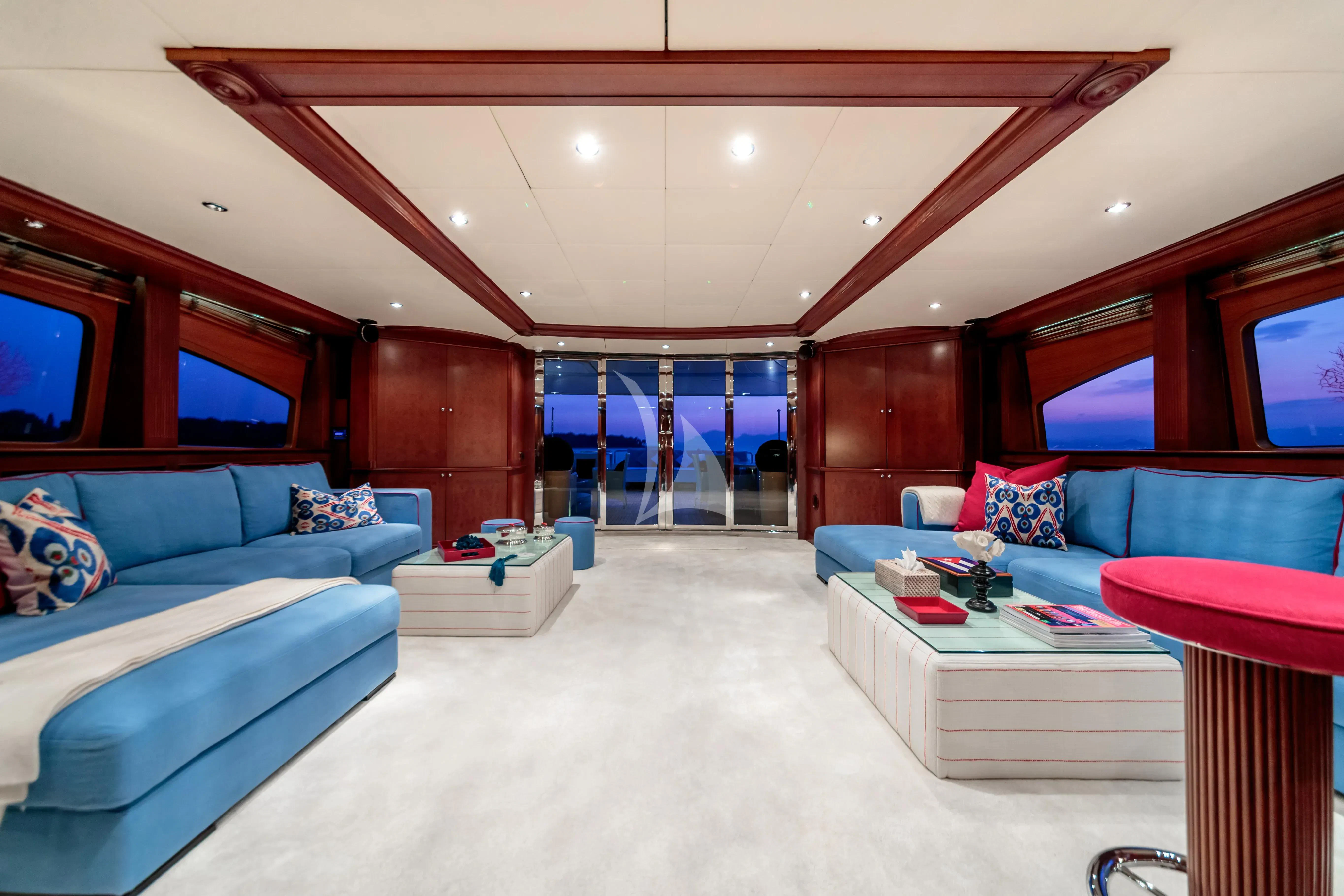 a living room with a large open door aboard BANG! Yacht for Charter