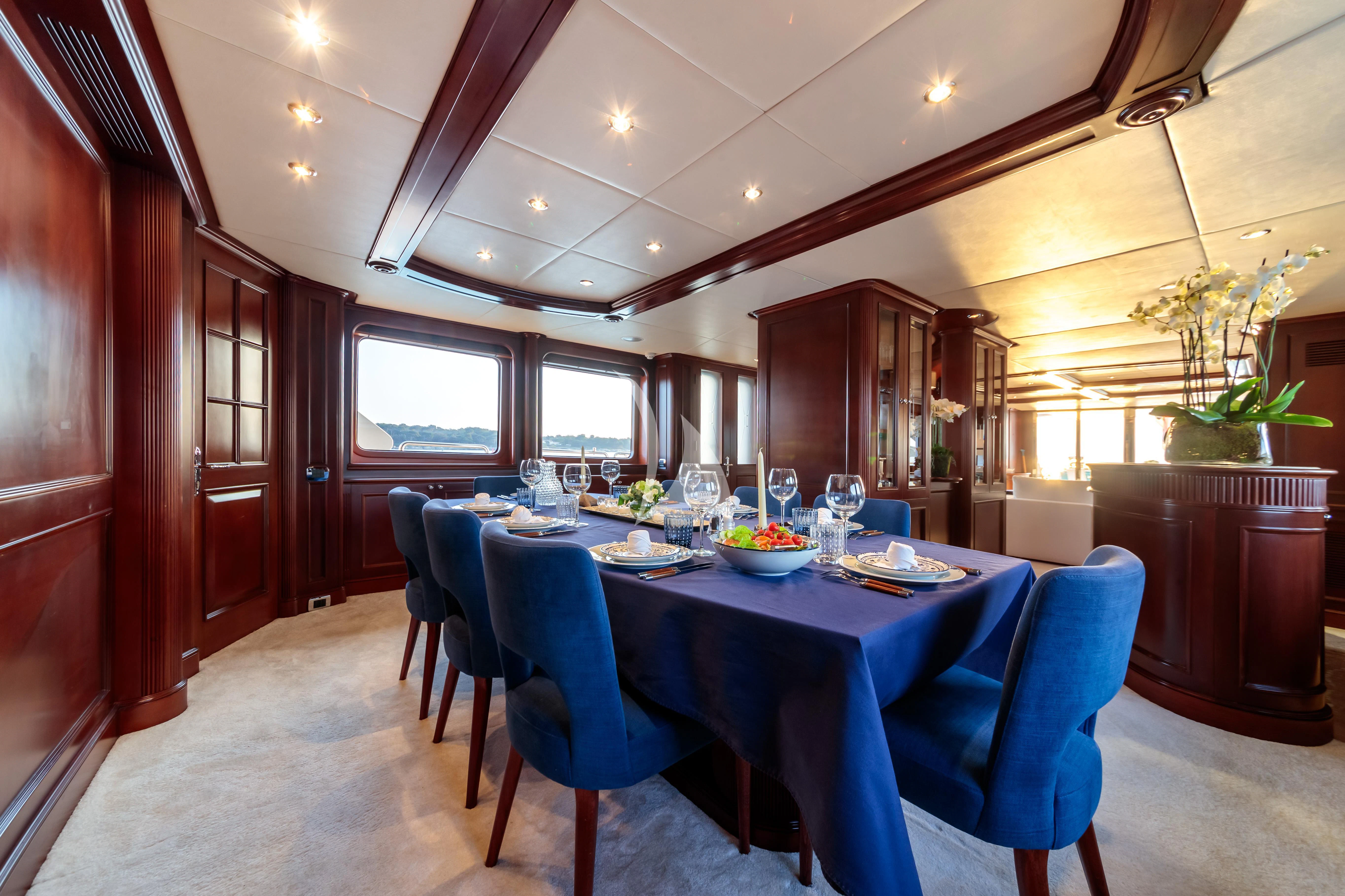 a dining room with a table and chairs aboard BANG! Yacht for Charter