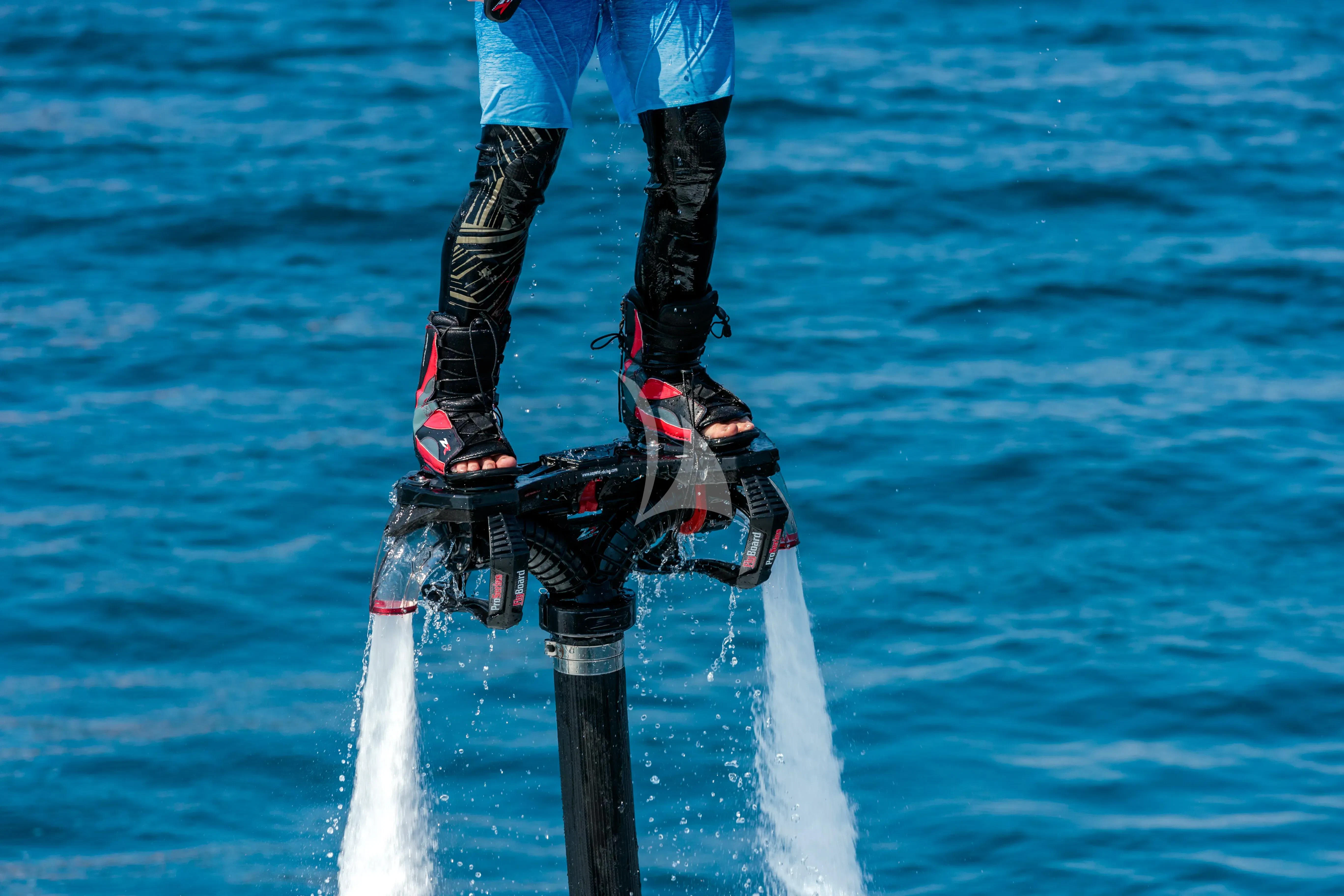a person on a pole in the water aboard BANG! Yacht for Charter