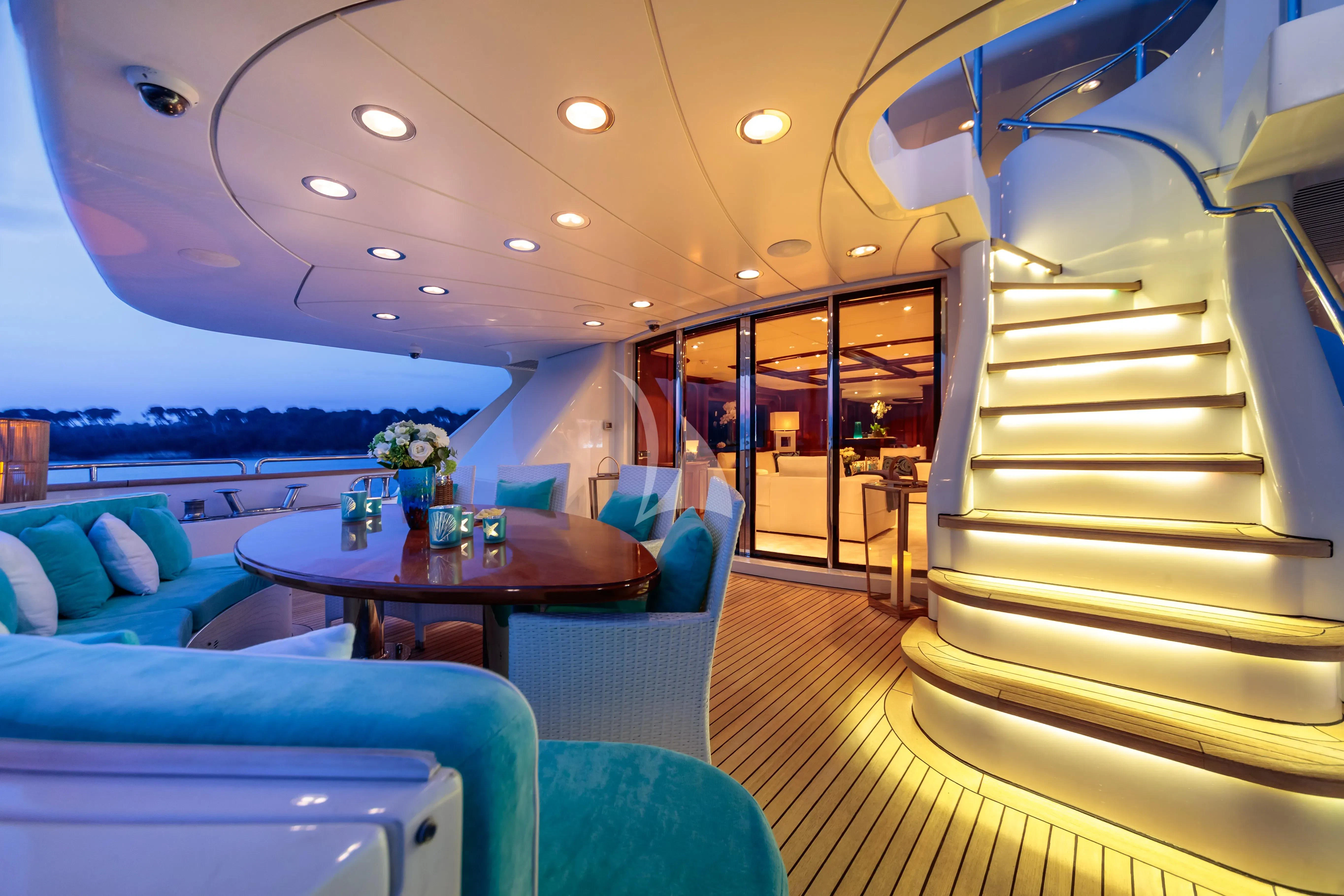 a room with a table and chairs aboard BANG! Yacht for Charter