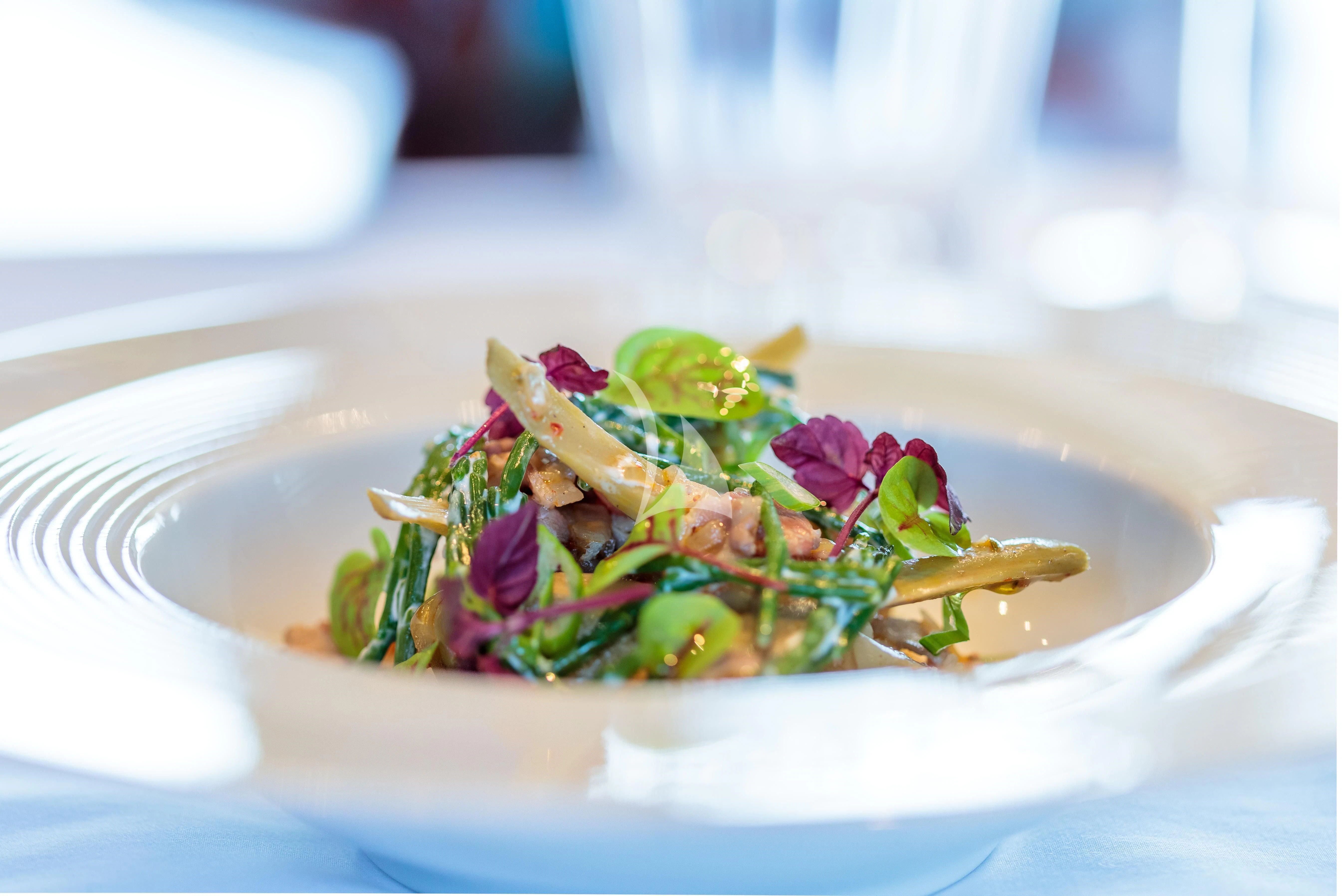 a plate of food aboard BANG! Yacht for Charter