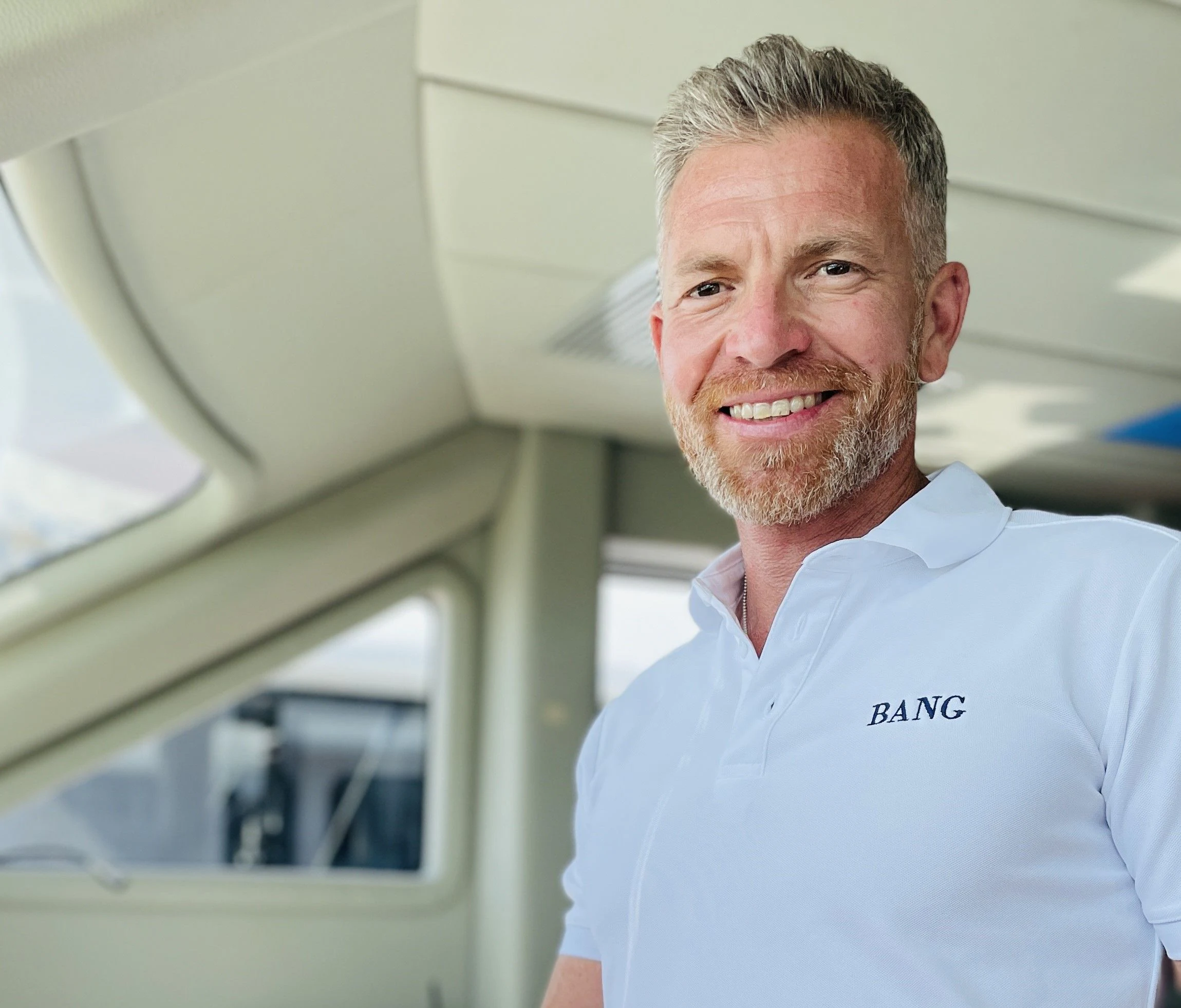 a man smiling for the camera aboard BANG! Yacht for Charter