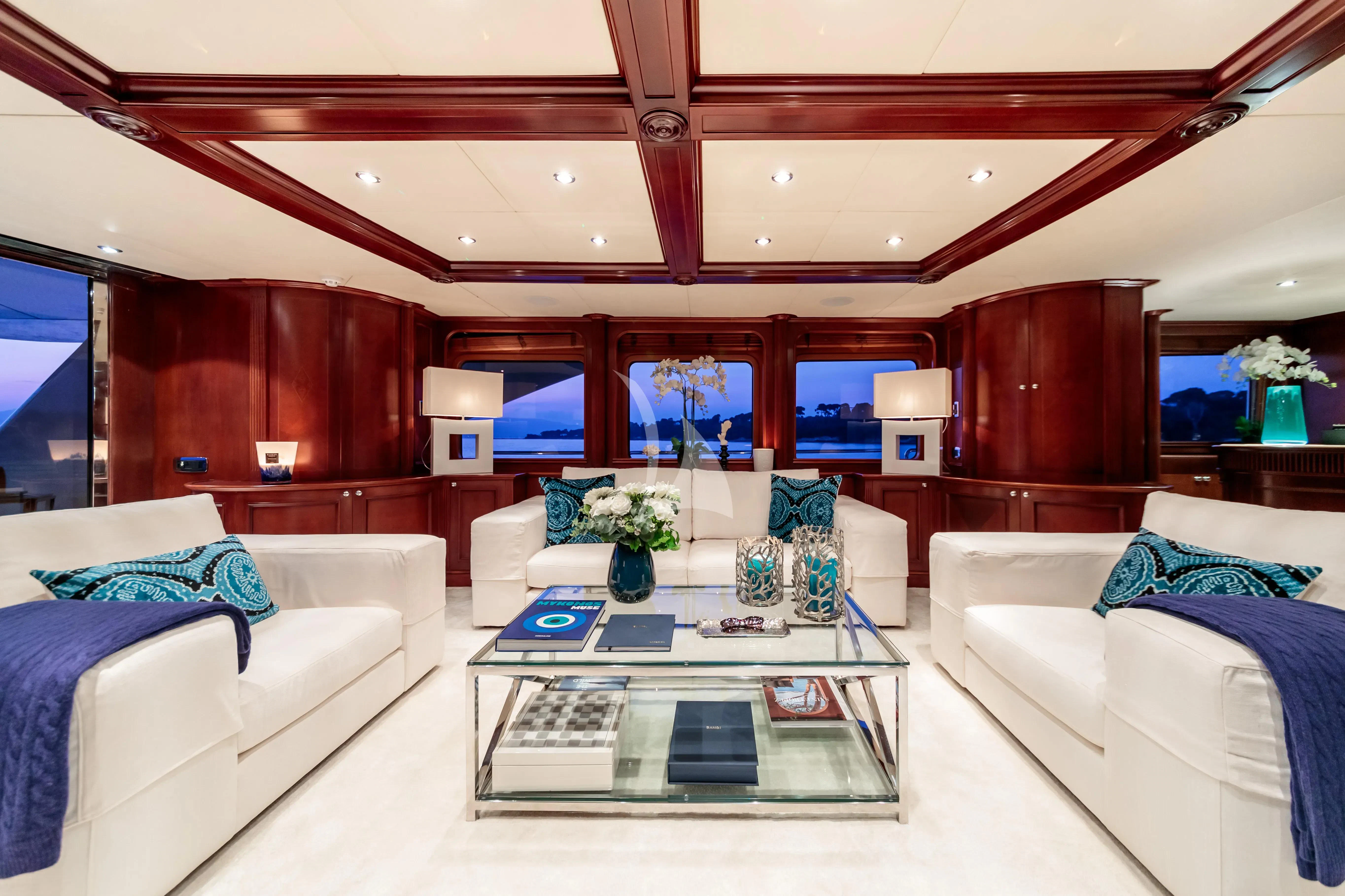 a living room with a large window aboard BANG! Yacht for Charter