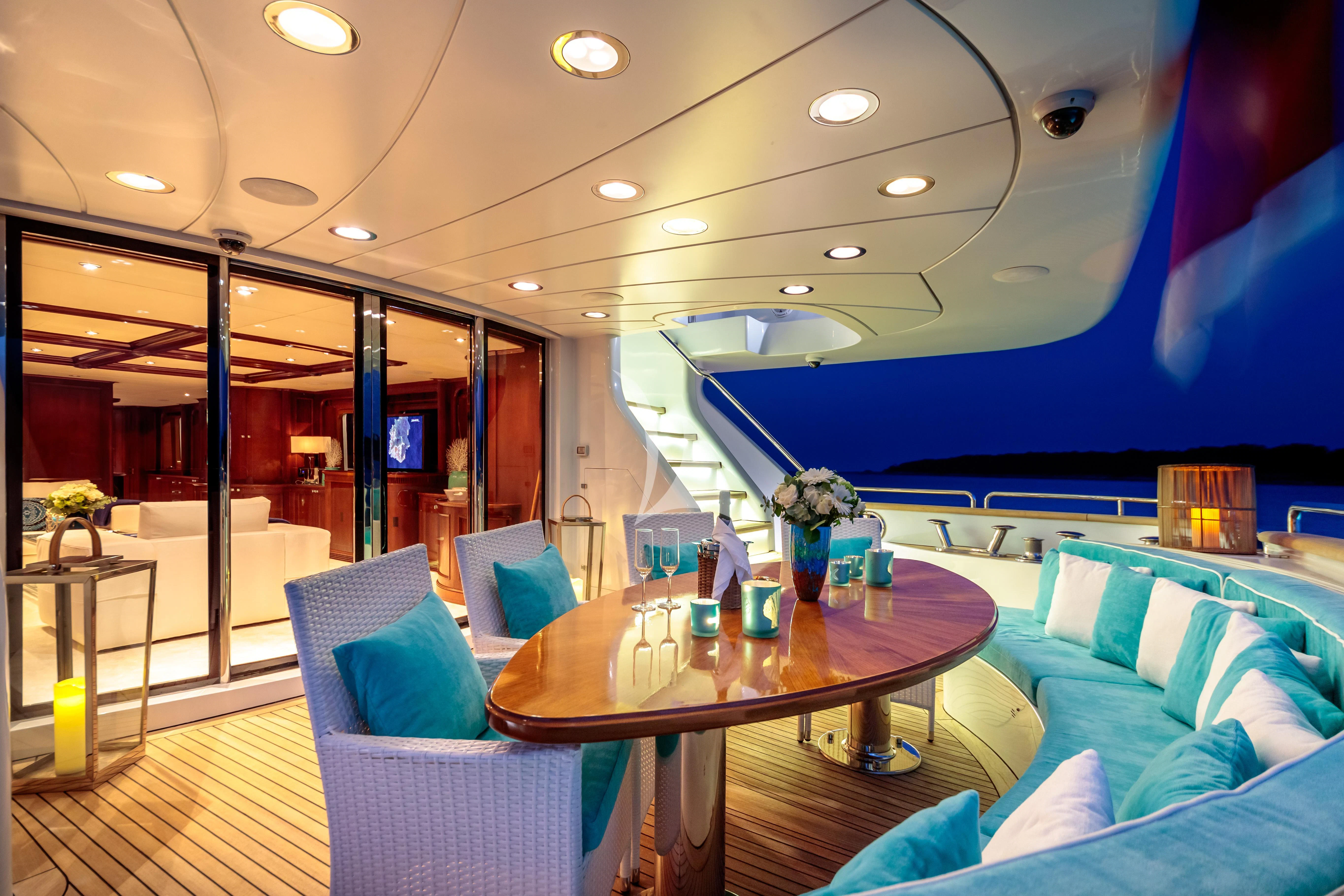 a room with a table and chairs aboard BANG! Yacht for Charter