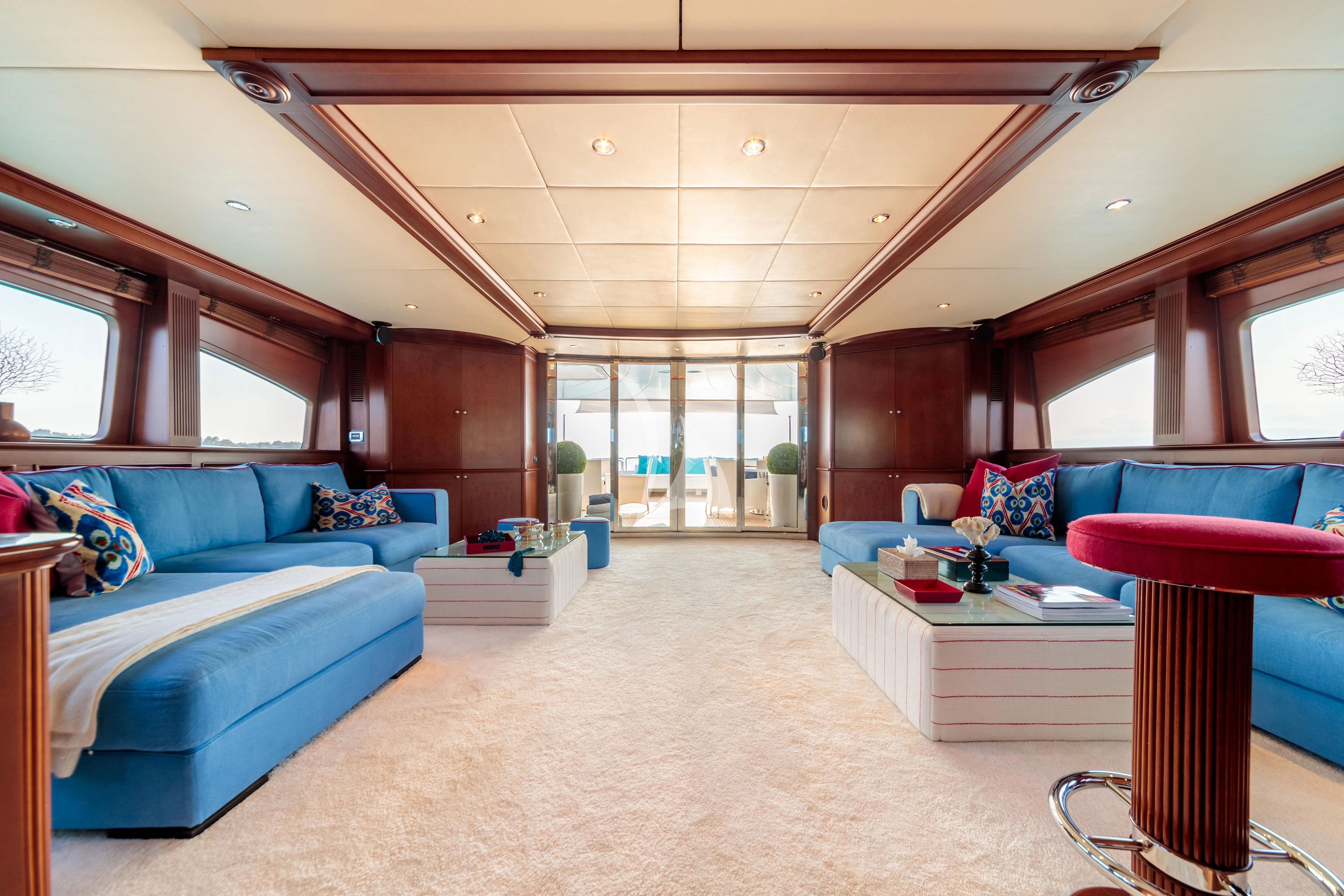 a room with a bed and a table aboard BANG! Yacht for Charter