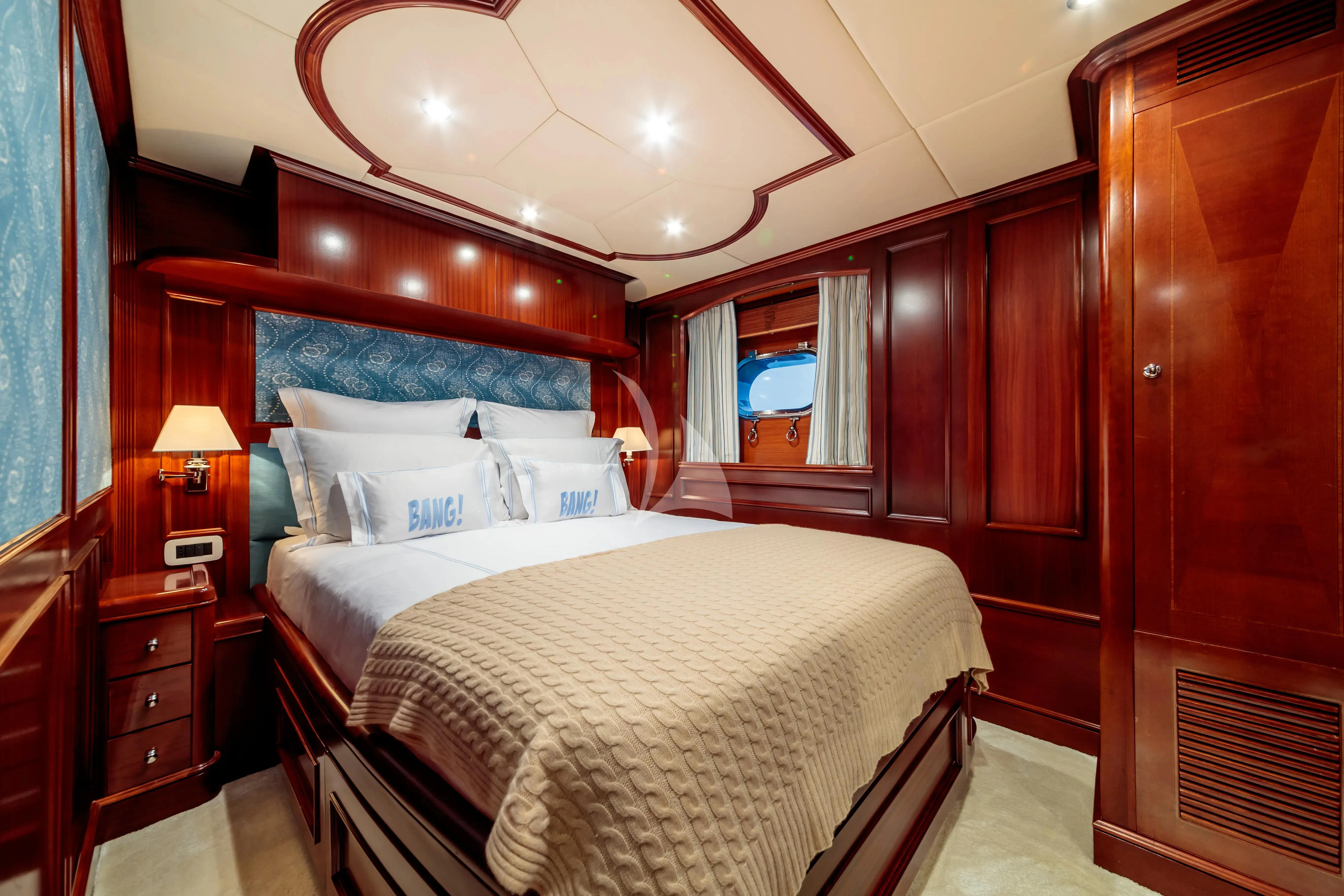 a room with a bed and a window aboard BANG! Yacht for Charter