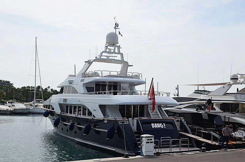 a large white boat with a red stripe on the front aboard BANG! Yacht for Charter