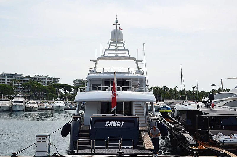 a boat is parked in a harbor aboard BANG! Yacht for Charter