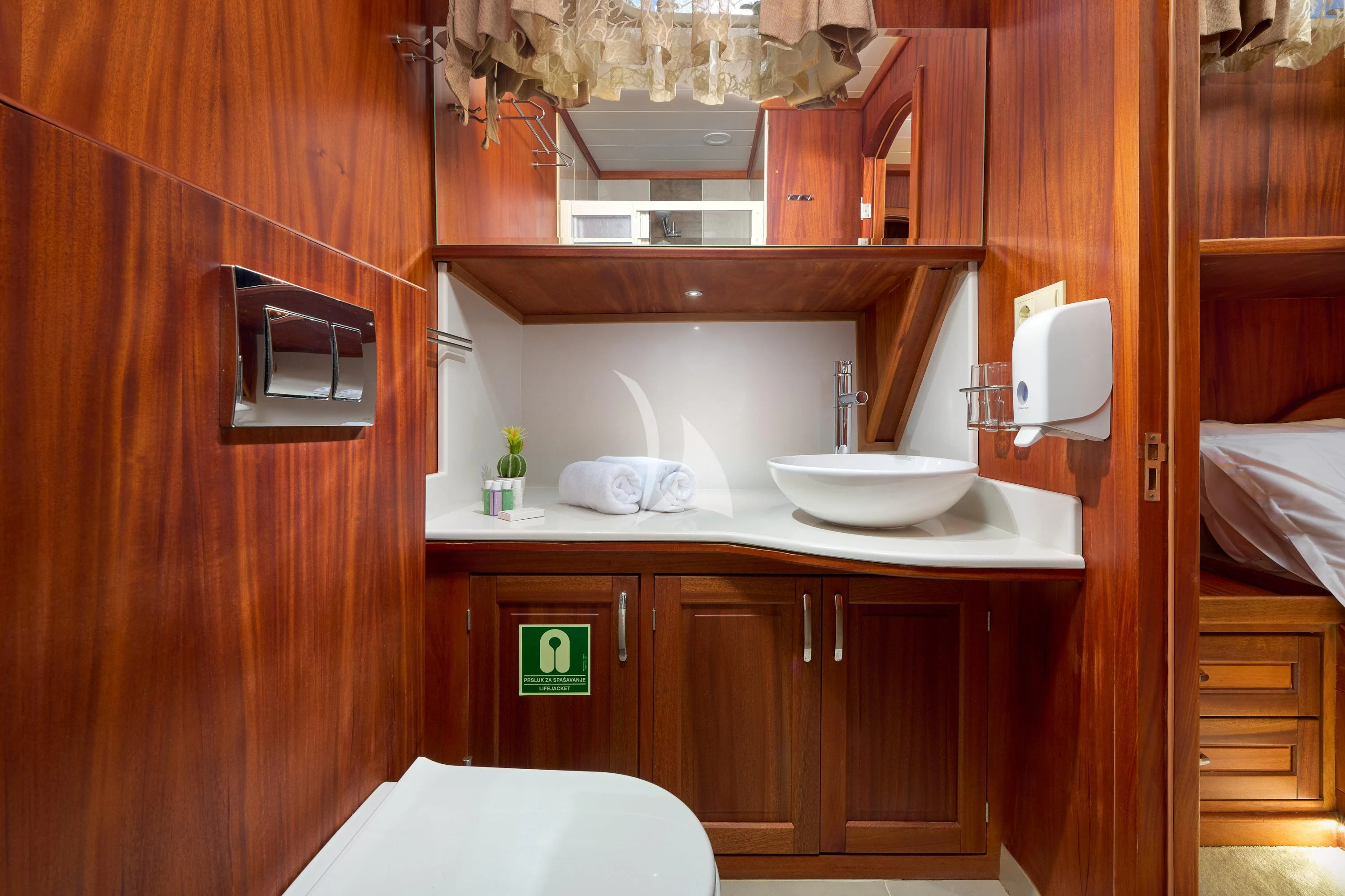 a bathroom with a sink and a mirror aboard SEA BREEZE Yacht for Charter