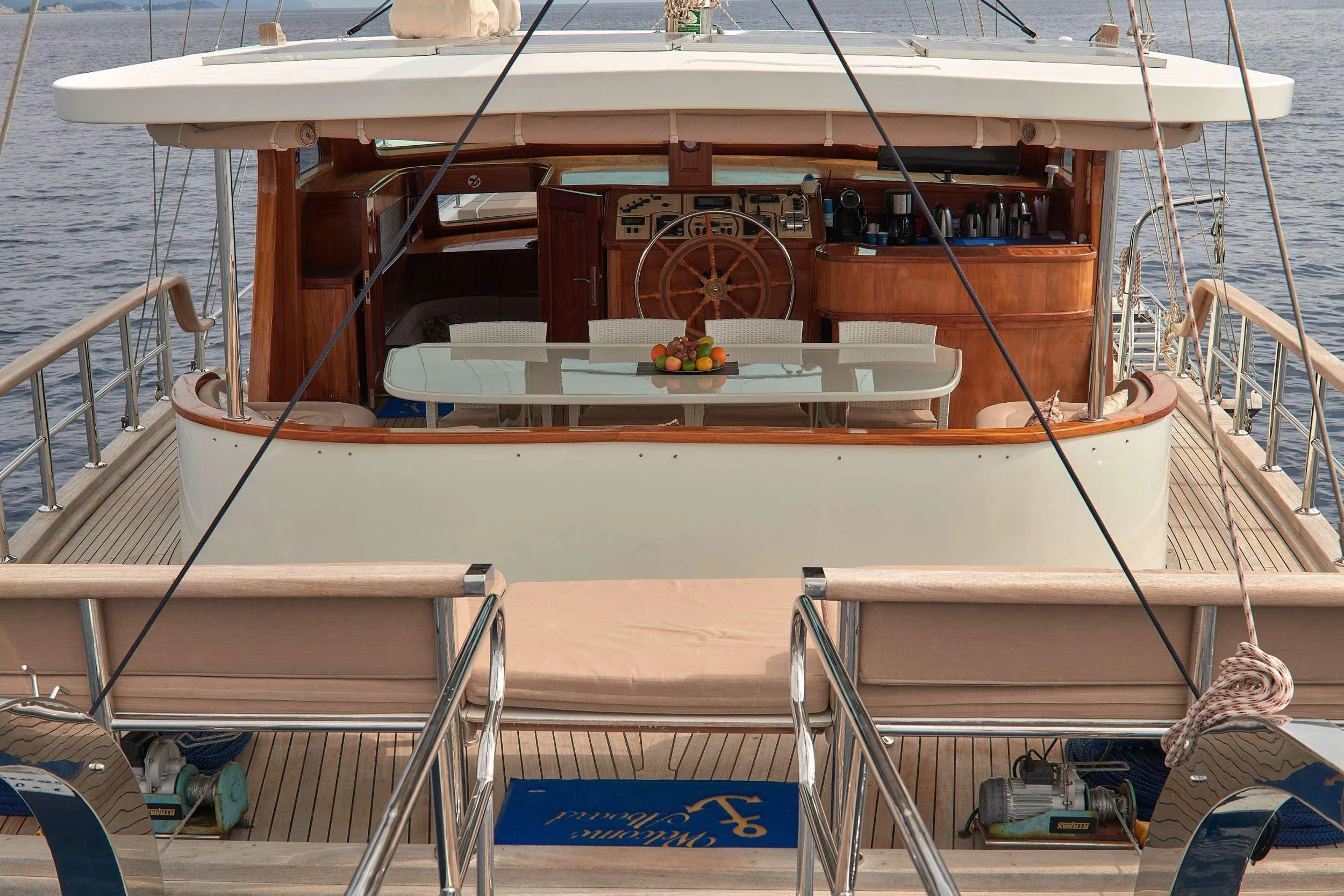 a boat with a table and chairs on the deck aboard SEA BREEZE Yacht for Charter