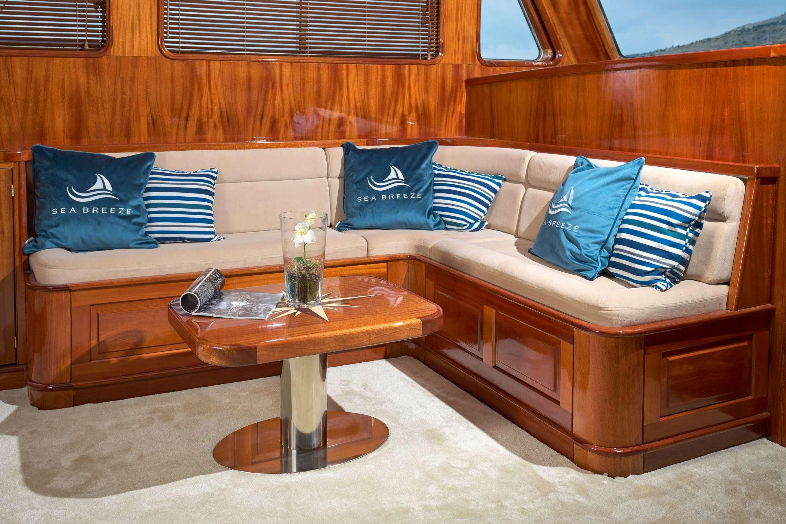 a couch with a coffee table aboard SEA BREEZE Yacht for Charter