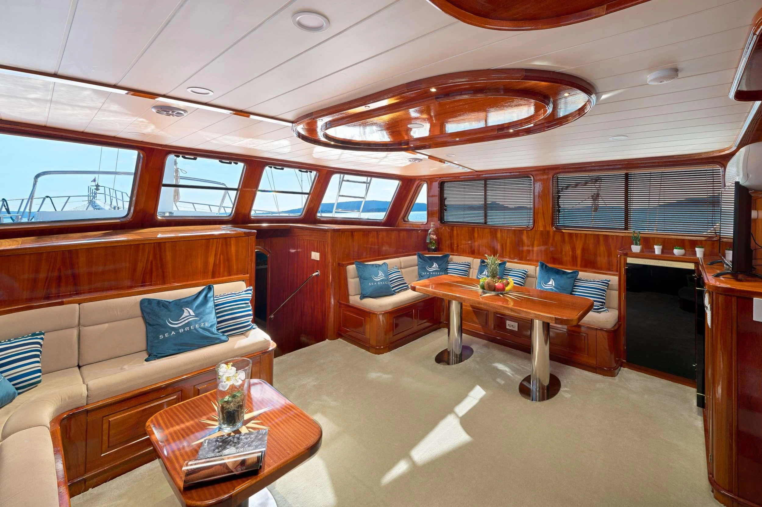 a living room with a couch and a table aboard SEA BREEZE Yacht for Charter