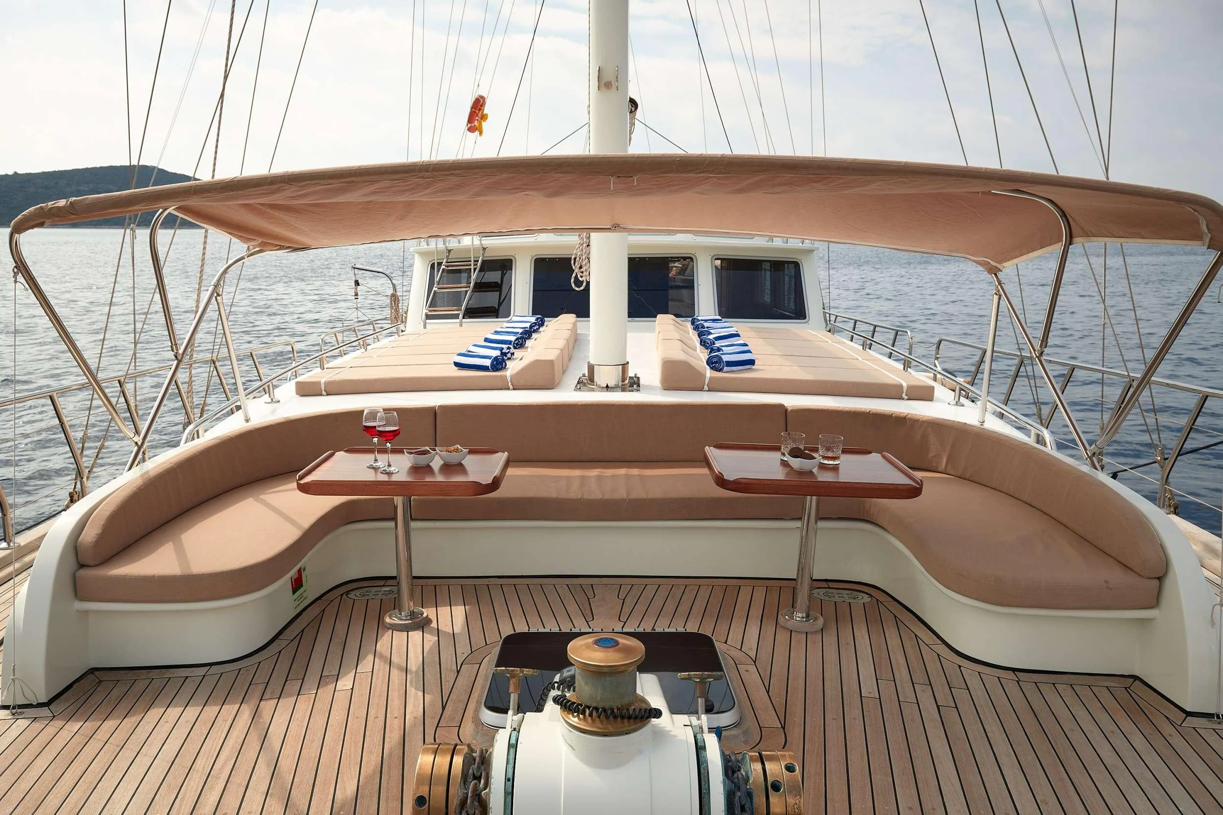 a deck with a table and chairs on it aboard SEA BREEZE Yacht for Charter