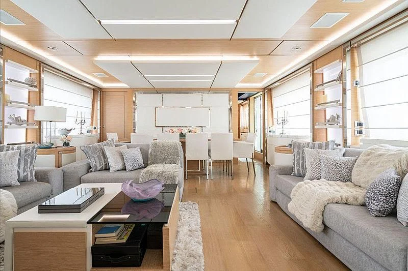 a living room with a couch and a table aboard PIXY Yacht for Sale