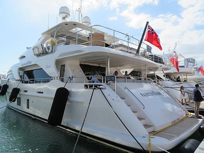 a boat with a flag on the front aboard PIXY Yacht for Sale
