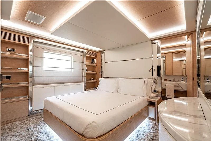 a bedroom with a bed and a window aboard PIXY Yacht for Sale